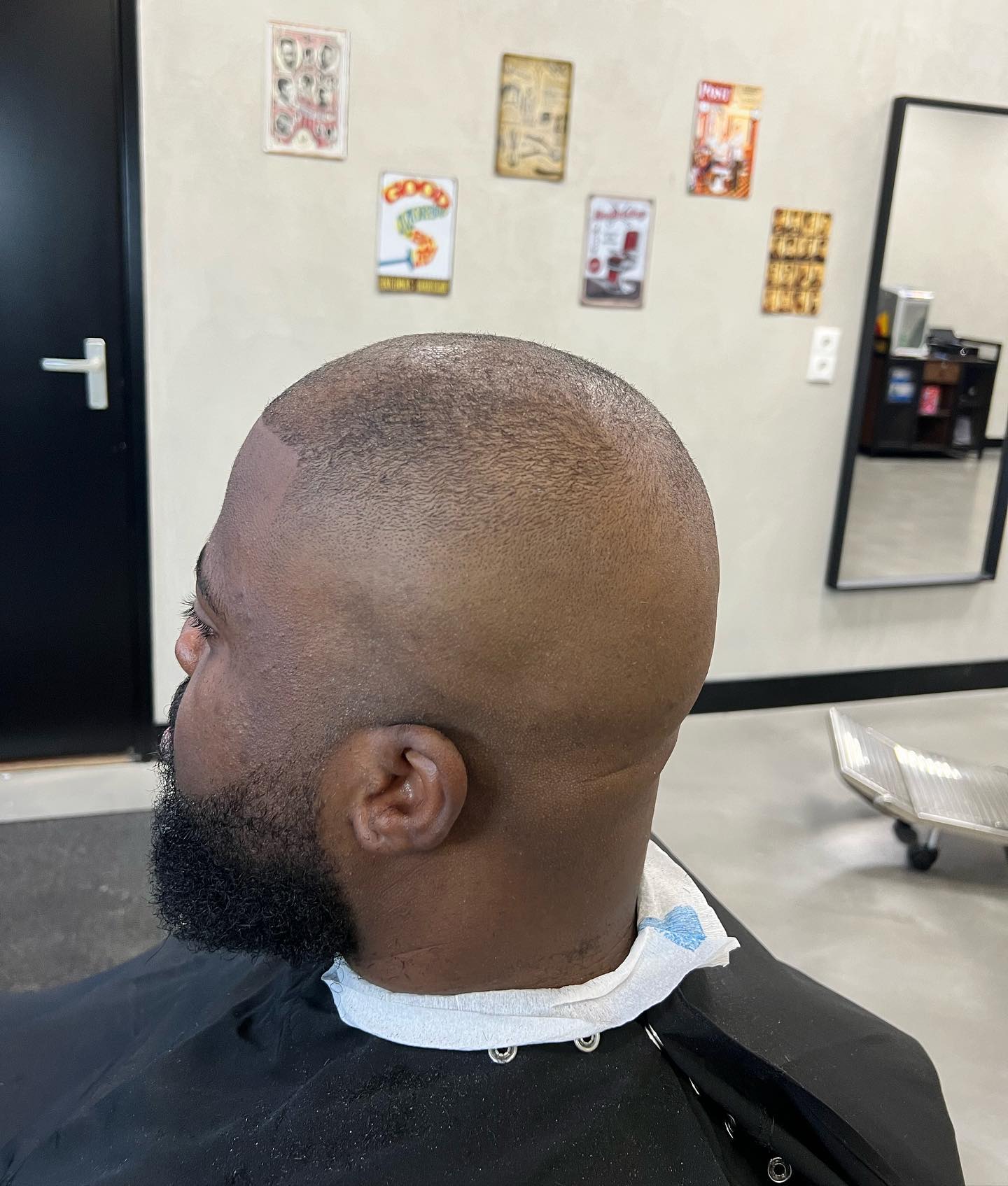 Gladgeschoren hoofd met een volle strak gevormde baard